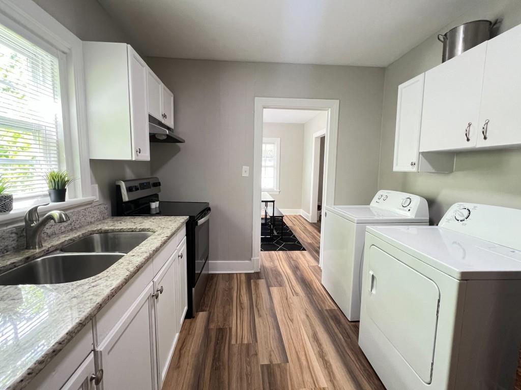 1076 Carlisle Avenue Macon, GA 31204 - Photo 7 of 16 a kitchen with a sink a stove and cabinets