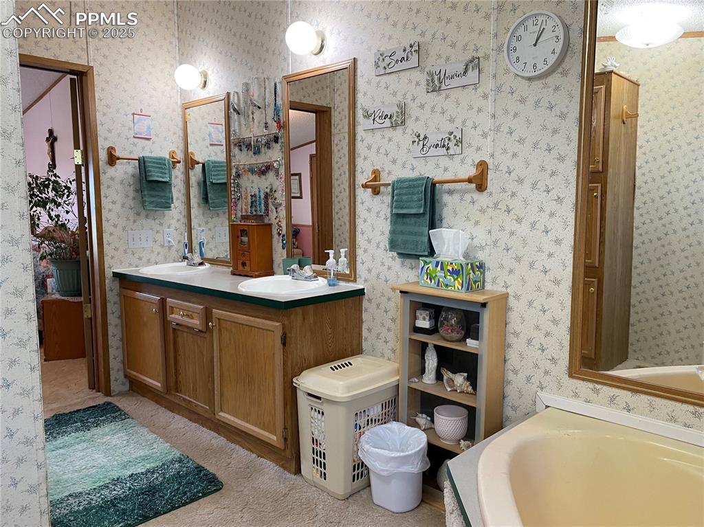 3955 South Meridian Road Colorado Springs, CO 80929 - Photo 15 of 39 a bathroom with a granite countertop toilet sink and mirror