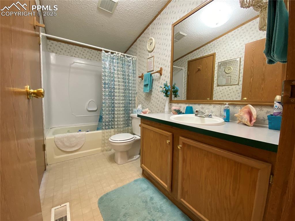 3955 South Meridian Road Colorado Springs, CO 80929 - Photo 18 of 39 a bathroom with a sink a toilet and shower