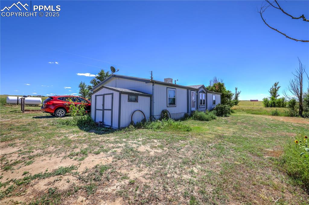 3955 South Meridian Road Colorado Springs, CO 80929 - Photo 21 of 39 a view of a house with a yard