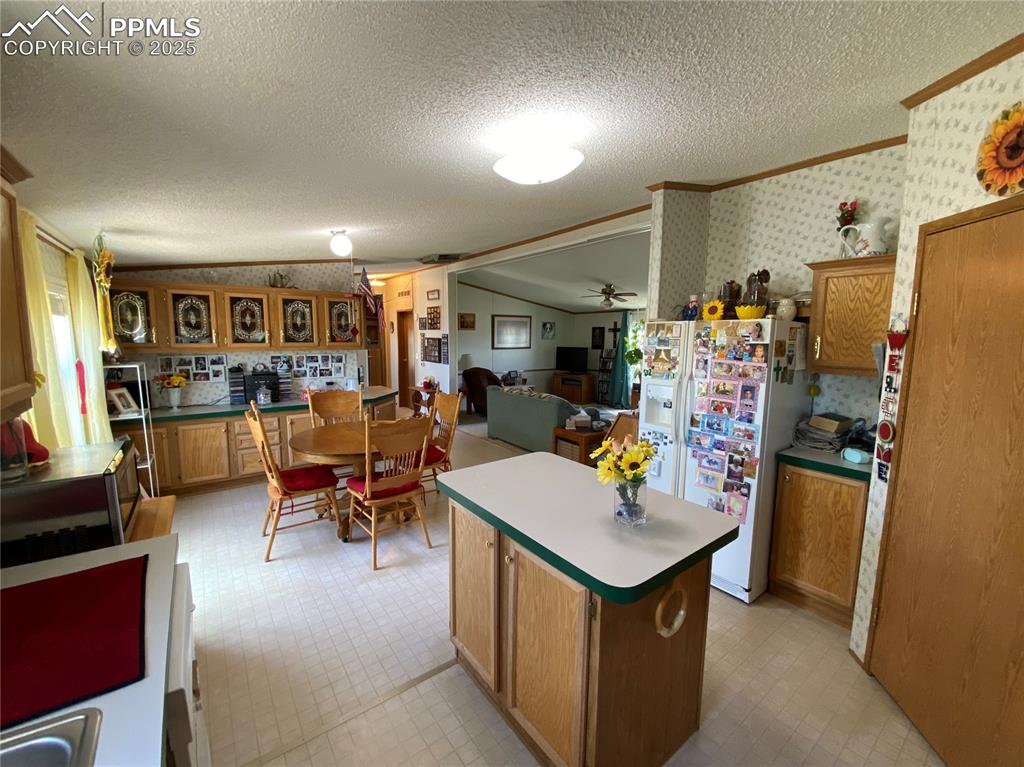 3955 South Meridian Road Colorado Springs, CO 80929 - Photo 8 of 39 a view of a open kitchen with furniture and a kitchen