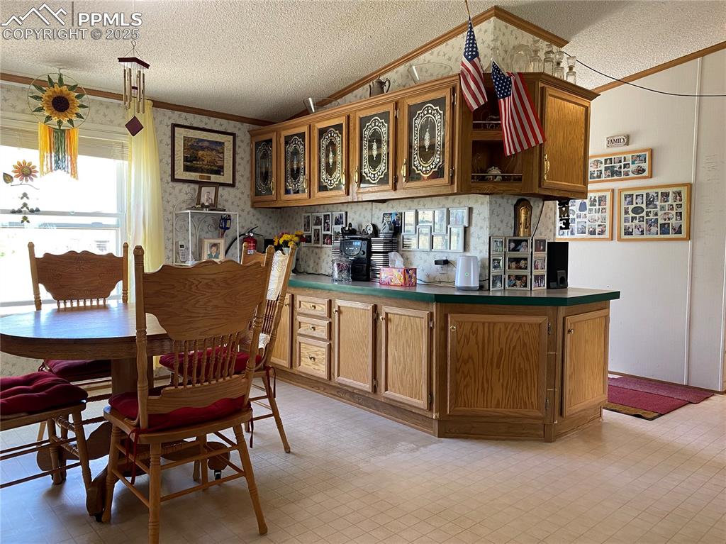 3955 South Meridian Road Colorado Springs, CO 80929 - Photo 10 of 39 a kitchen with stainless steel appliances granite countertop a dining table and chairs