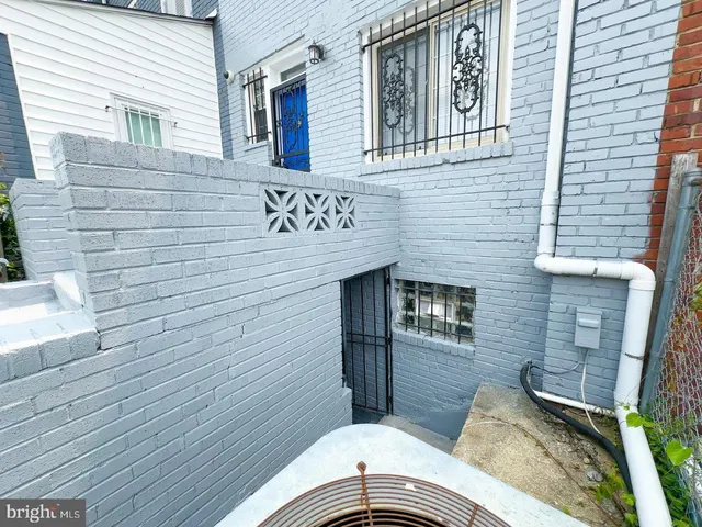 a view of a brick house with many windows