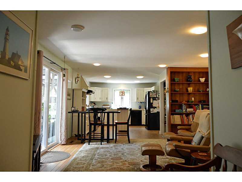 270 Biscuit City Road Charlestown, RI 02813 - Photo 11 of 25 Den/Family/Great Room. open kitchen/family room with wood stove & sliders to that amazing porch!