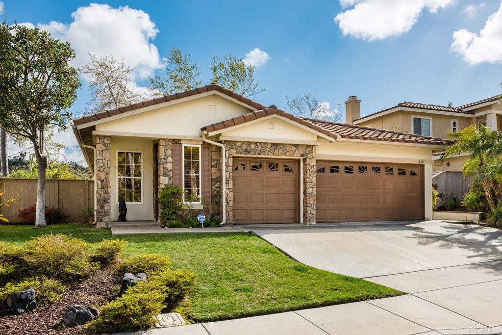 2861 Rancho Rio Chico Carlsbad, CA 92009 - Photo 1 of 1 a front view of a house with a garden