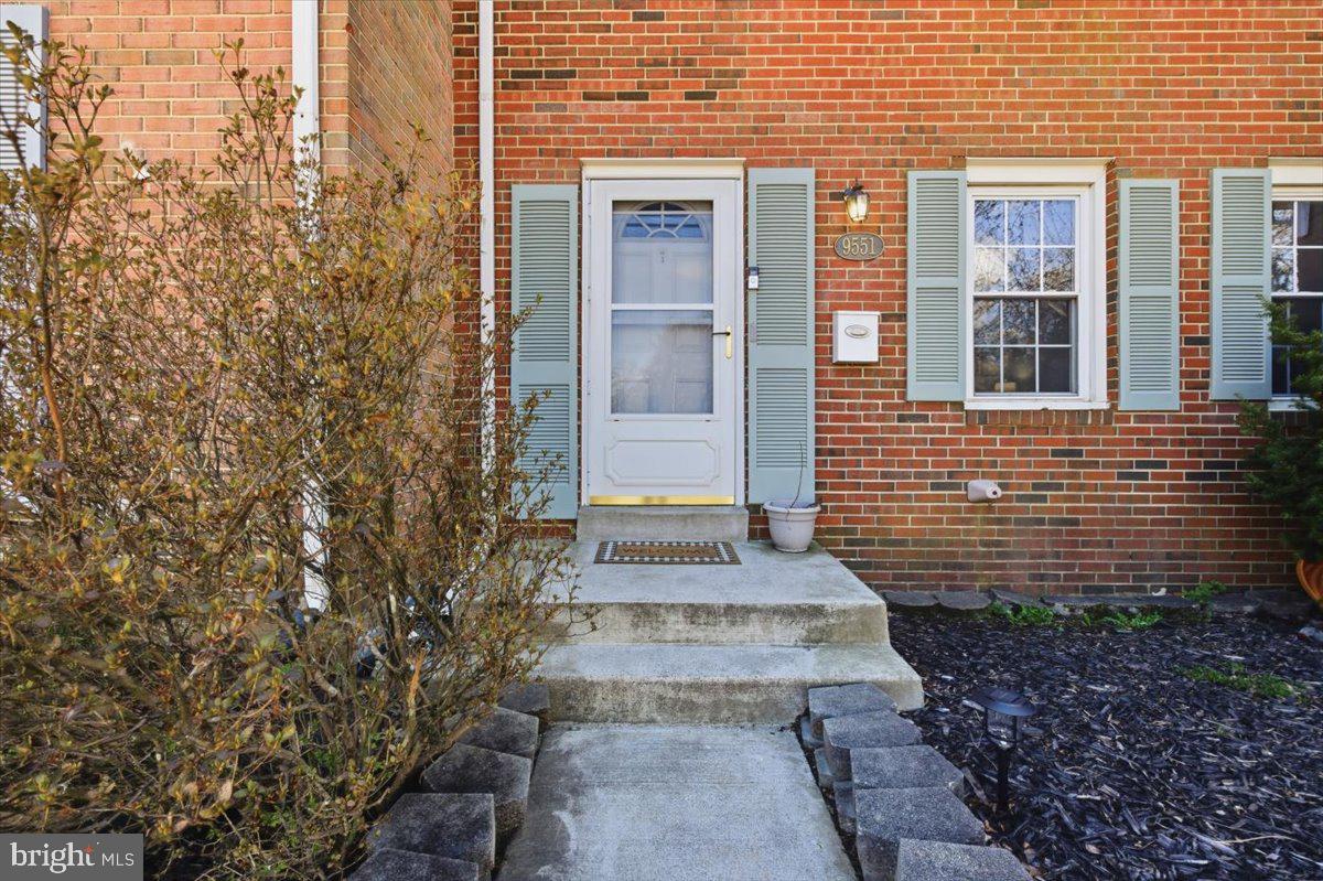 9551 Covington Place Manassas, VA 20109 - Photo 3 of 24 a view of a brick house with many windows