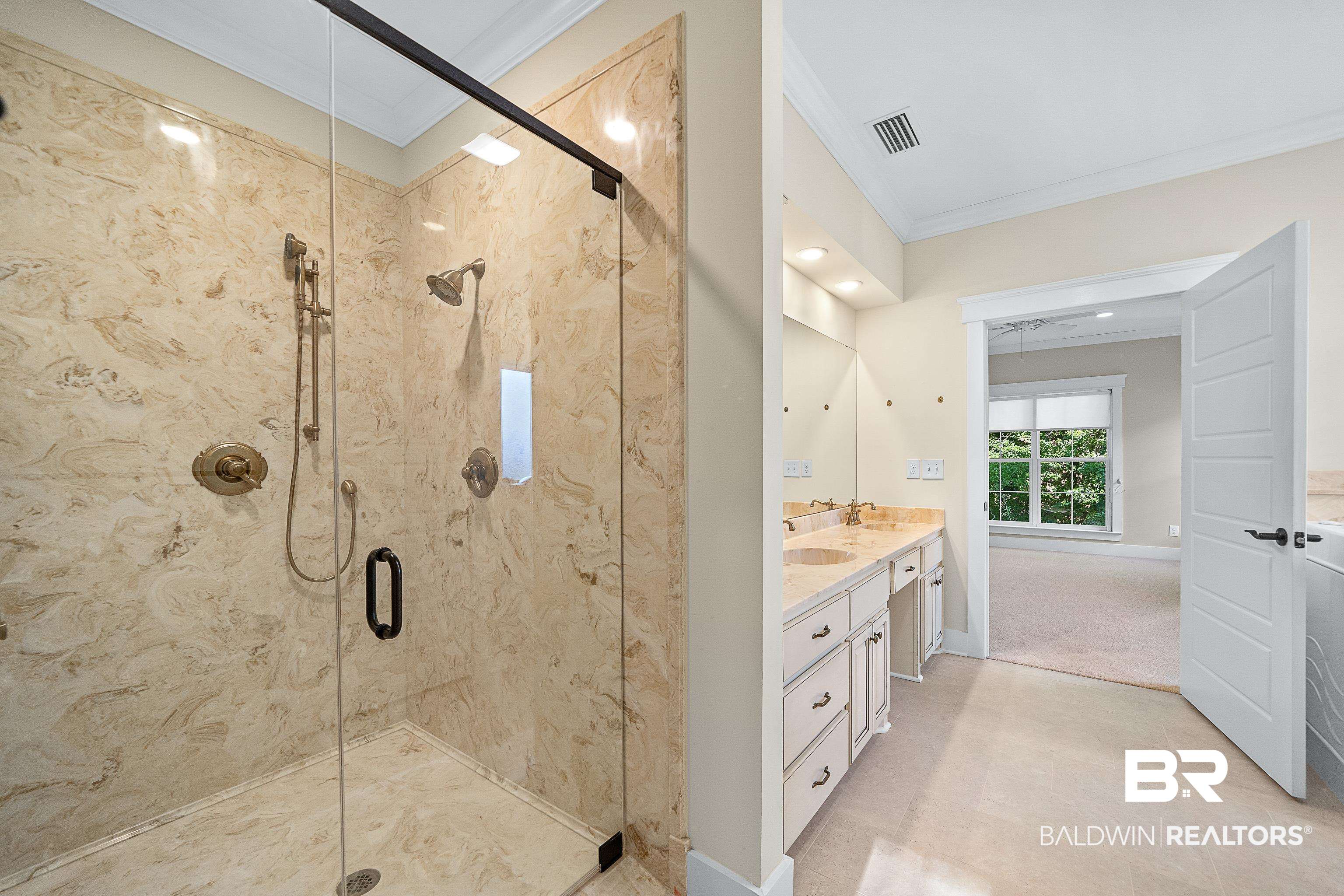356 Liberty Street Fairhope, AL 36532 - Photo 16 of 39 Bathroom with ornamental molding, double vanity, and a stall shower