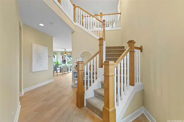 a view of entryway and hall with wooden floor