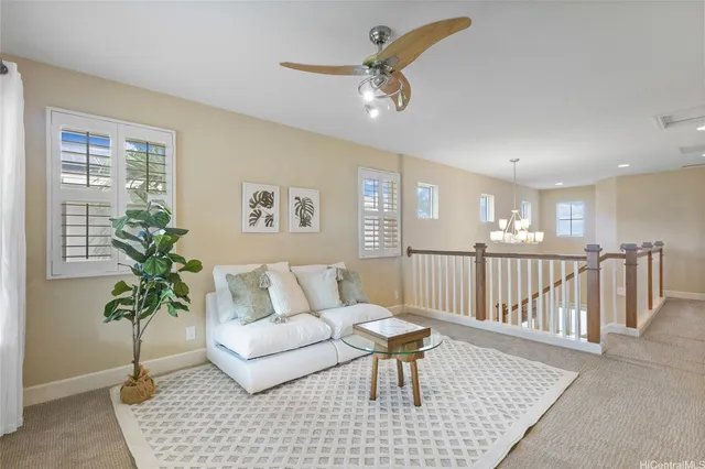 a living room with furniture and a potted plant