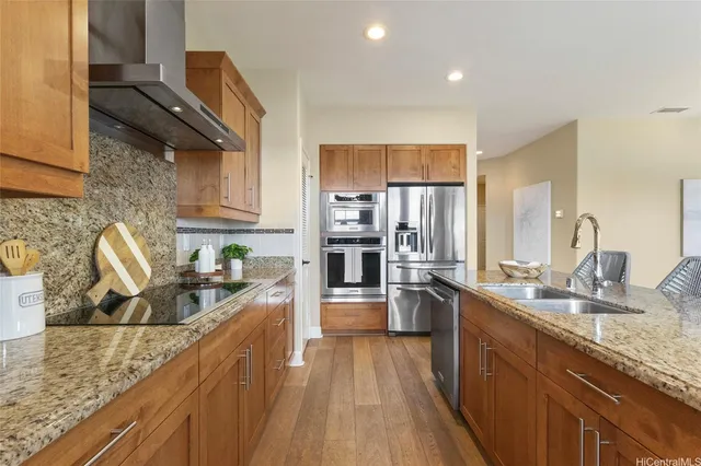 a kitchen with stainless steel appliances granite countertop a sink stove and refrigerator