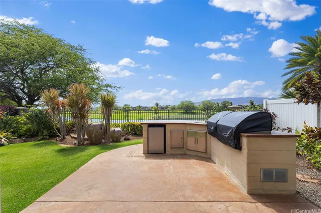 a view of a patio with couches and table and chairs and potted plants