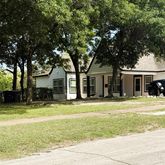 a house that has a big yard with large trees