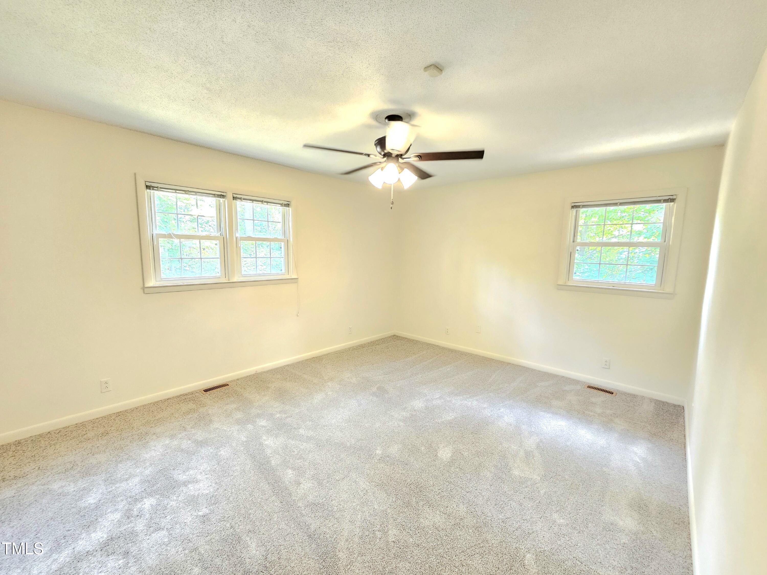 400 Harrill Circle Spring Lake, NC 28390 - Photo 13 of 25 an empty room with windows and ceiling fan