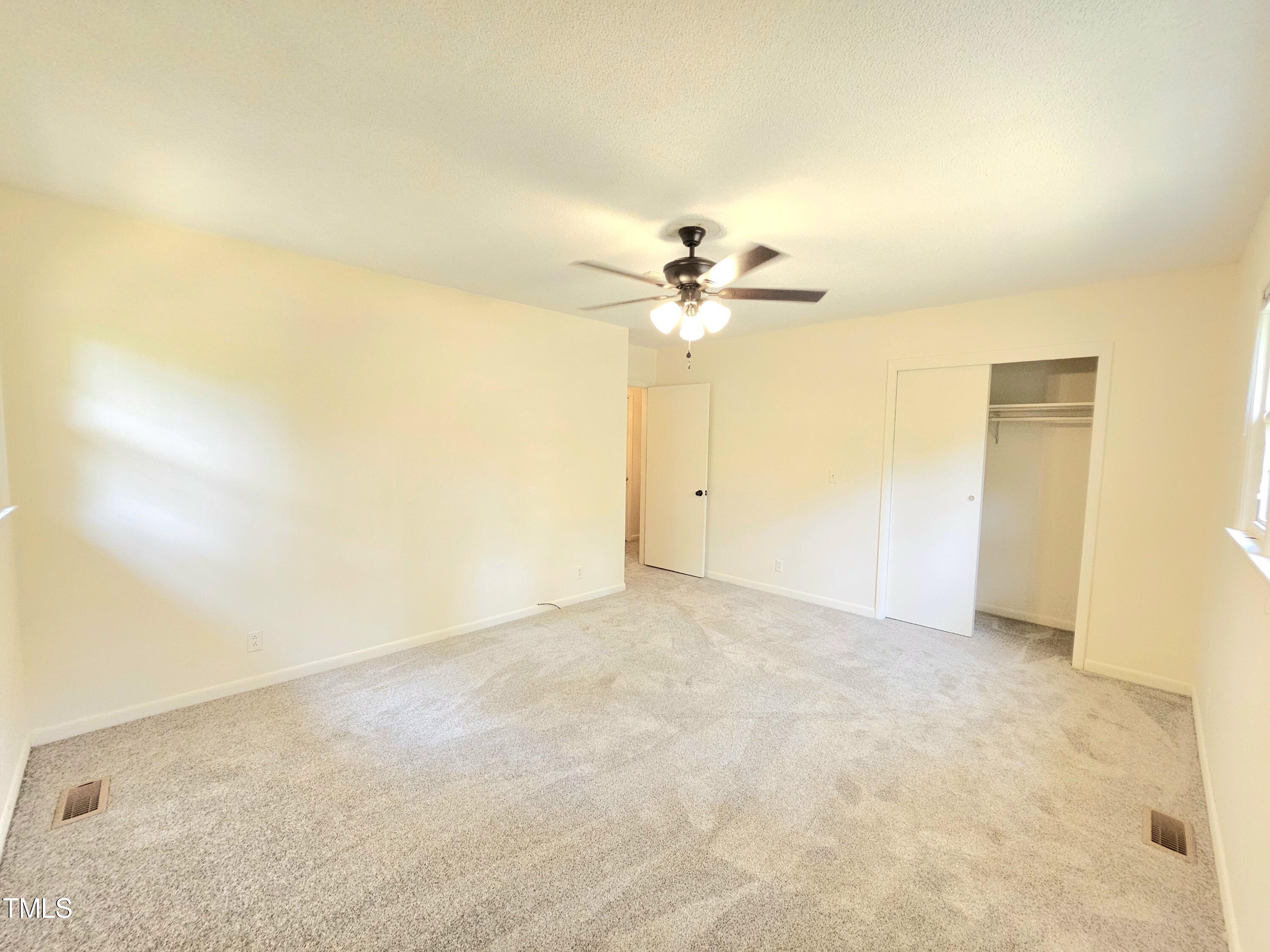 400 Harrill Circle Spring Lake, NC 28390 - Photo 15 of 25 an empty room with a chandelier fan and closet