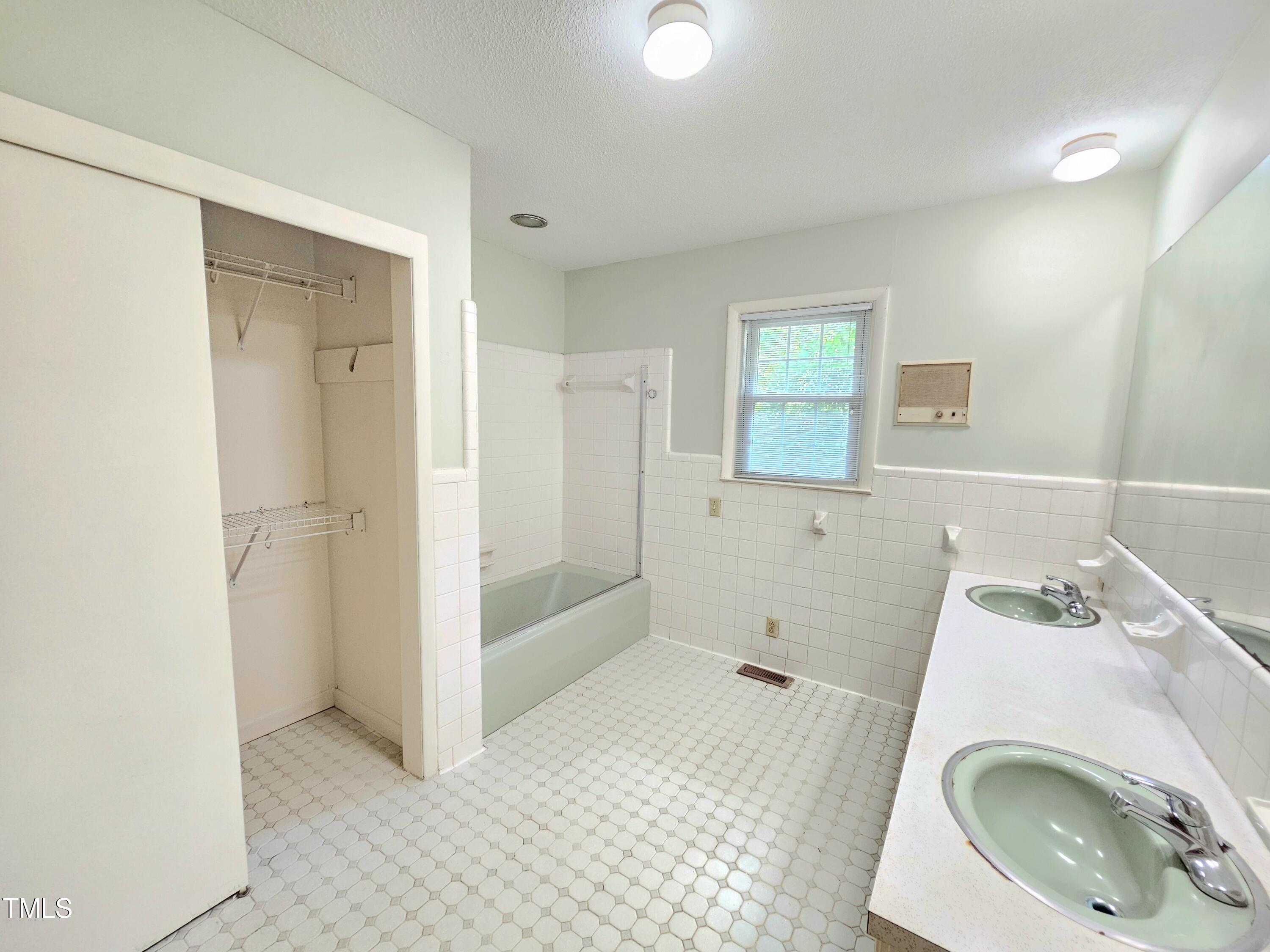 400 Harrill Circle Spring Lake, NC 28390 - Photo 18 of 25 a bathroom with a sink a toilet and shower