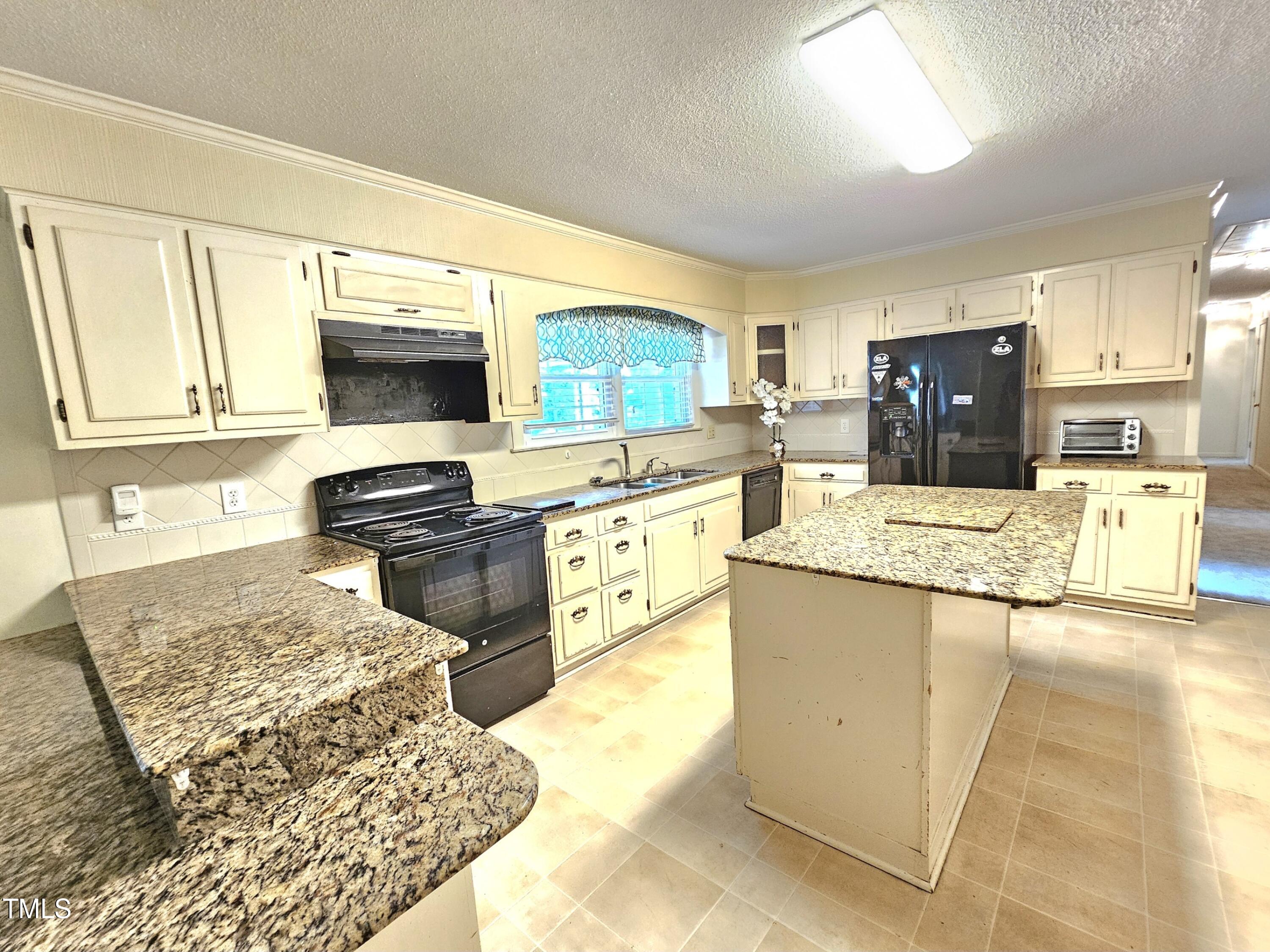 400 Harrill Circle Spring Lake, NC 28390 - Photo 5 of 25 a kitchen with stainless steel appliances granite countertop a sink stove and refrigerator