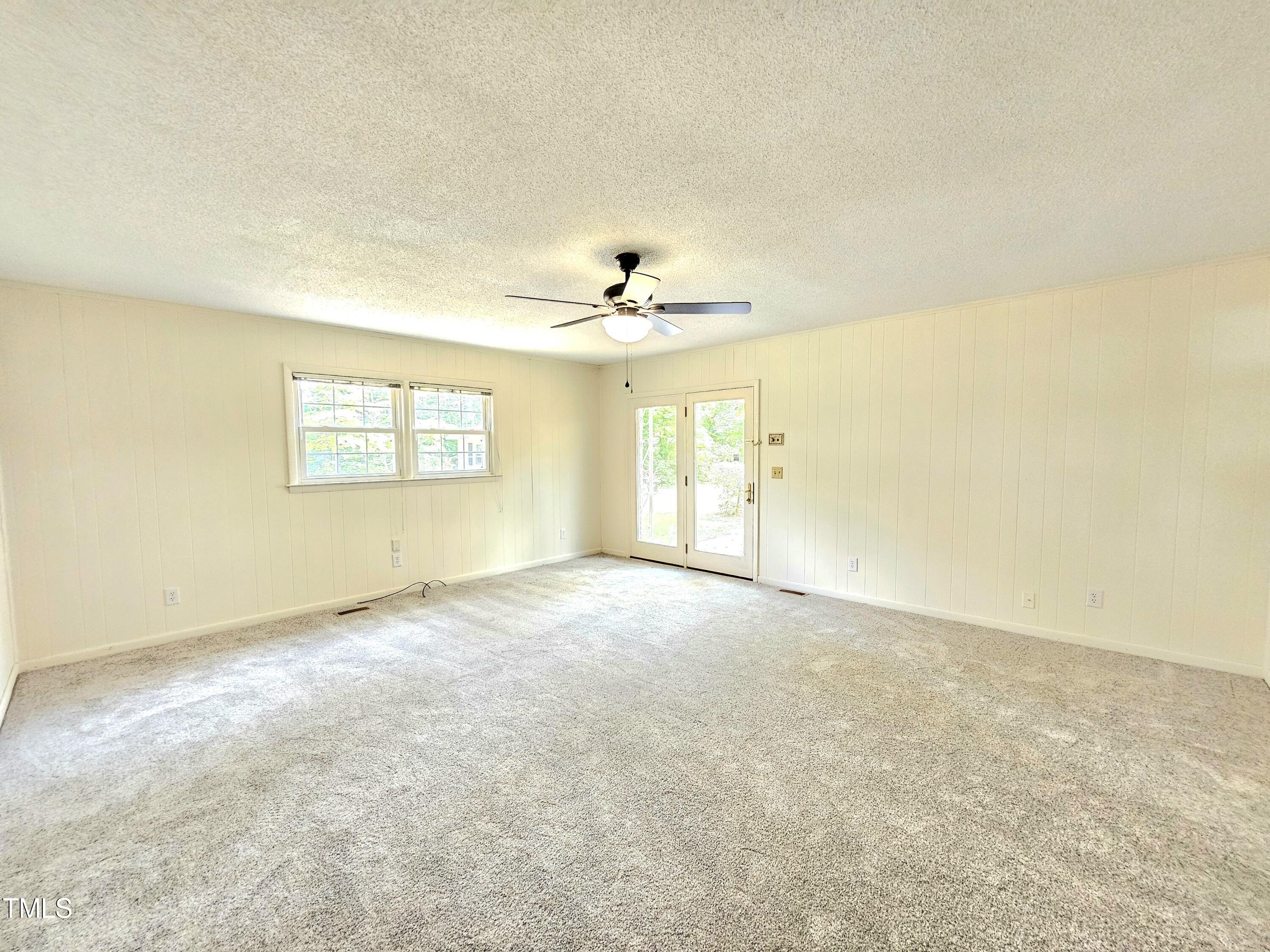 400 Harrill Circle Spring Lake, NC 28390 - Photo 7 of 25 an empty room with a window and a ceiling fan