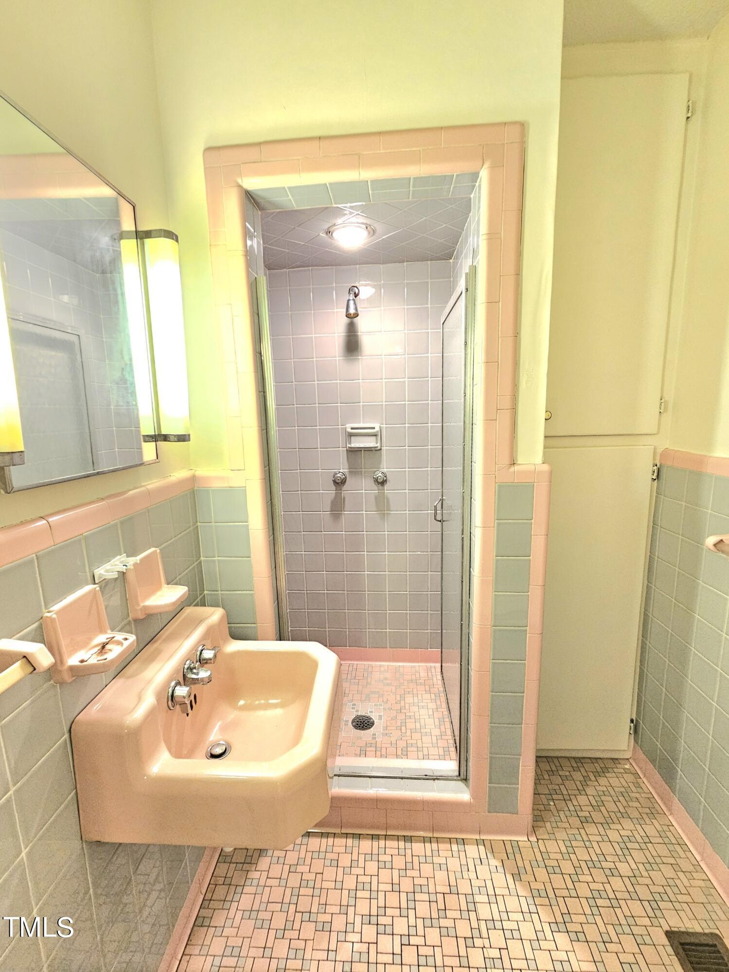 400 Harrill Circle Spring Lake, NC 28390 - Photo 10 of 25 a bathroom with a sink a toilet and shower