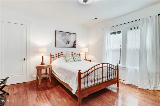 a bedroom with a bed and a large window