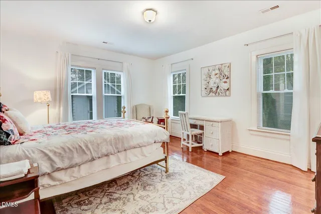a living room with furniture and a painting on the wall