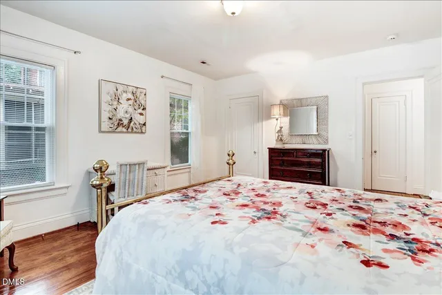 a bedroom with a bed window and table