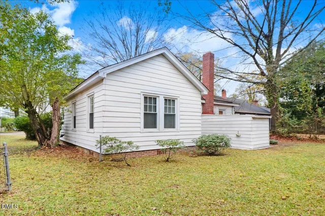 a view of a house with a yard covered in snow
