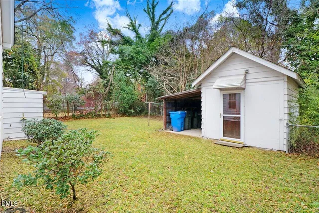 a view of a fire pit with large trees