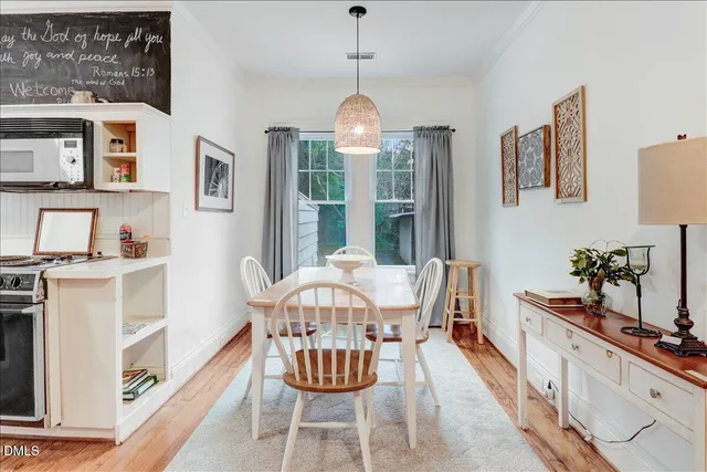 a dining room with furniture a chandelier and wooden floor
