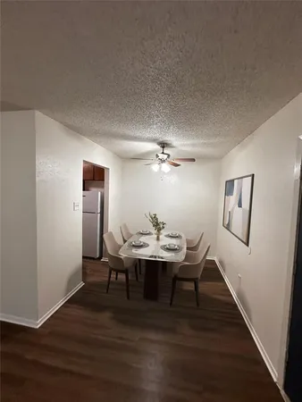 a bathroom with a granite countertop sink a mirror and shower