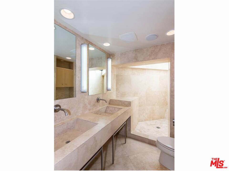 734 Esplanade, Unit A/B Redondo Beach, CA 90277 - Photo 14 of 40 a bathroom with a granite countertop sink a mirror and a bathtub