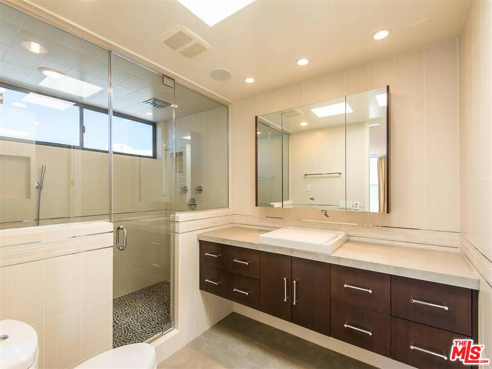 734 Esplanade, Unit A/B Redondo Beach, CA 90277 - Photo 20 of 40 a bathroom with a granite countertop sink a toilet and a mirror
