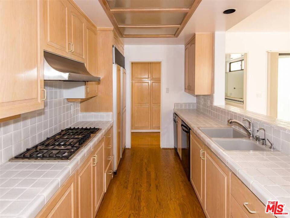 734 Esplanade, Unit A/B Redondo Beach, CA 90277 - Photo 25 of 40 a kitchen with sink a stove and cabinets