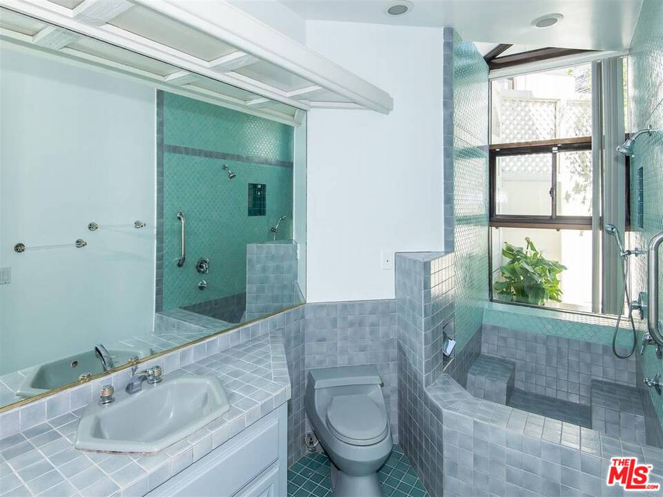 734 Esplanade, Unit A/B Redondo Beach, CA 90277 - Photo 29 of 40 a bathroom with a granite countertop sink toilet and shower