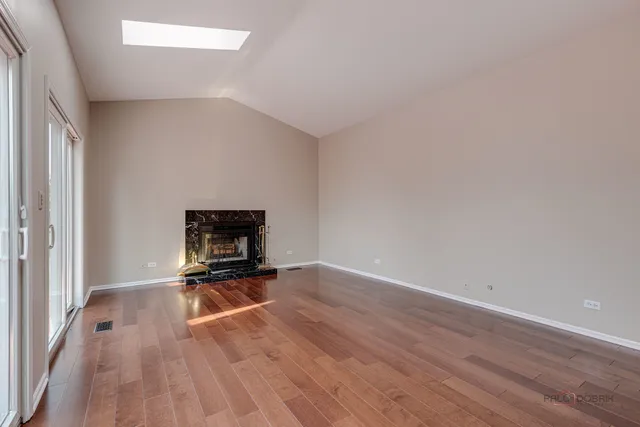 a view of an empty room and wooden floor