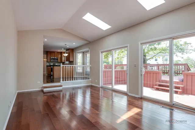 a view of a room with wooden floor and floor to ceiling window
