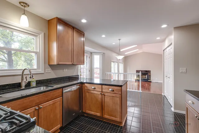 a kitchen with stainless steel appliances granite countertop a sink stove and cabinets