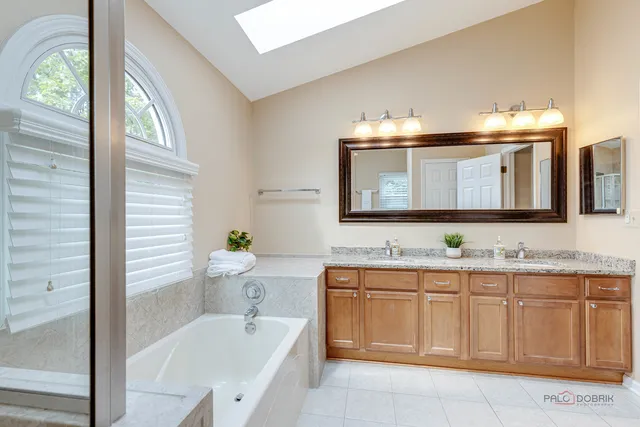 a bathroom with a double vanity sink and a mirror