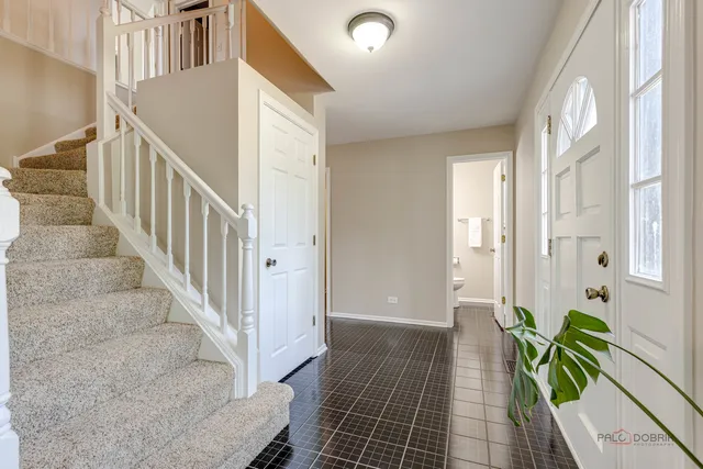 a view of an entryway with wooden floor and stairs