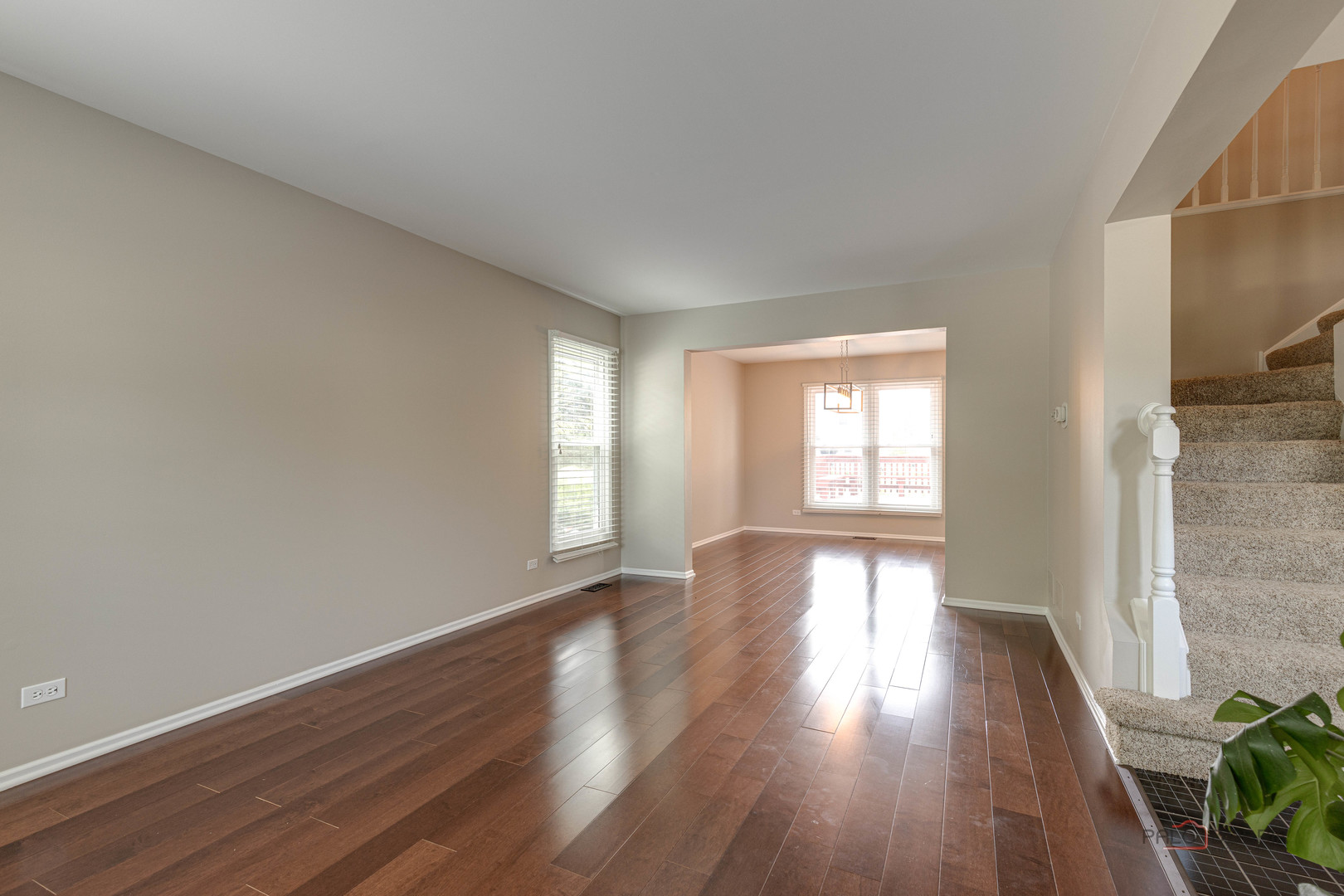 285 Stanton Drive Buffalo Grove, IL 60089 - Photo 9 of 36 a view of an empty room with wooden floor and a window