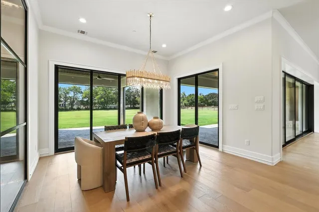a dining room with furniture window and wooden floor