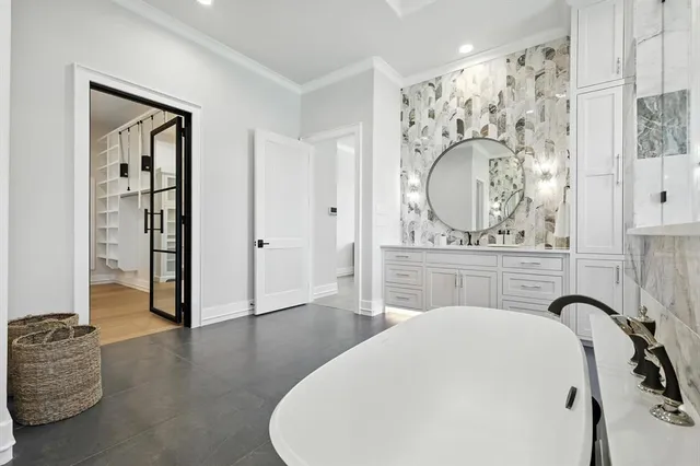 a bathroom with a tub sink and mirror