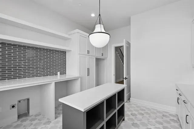 a kitchen with a sink and cabinets