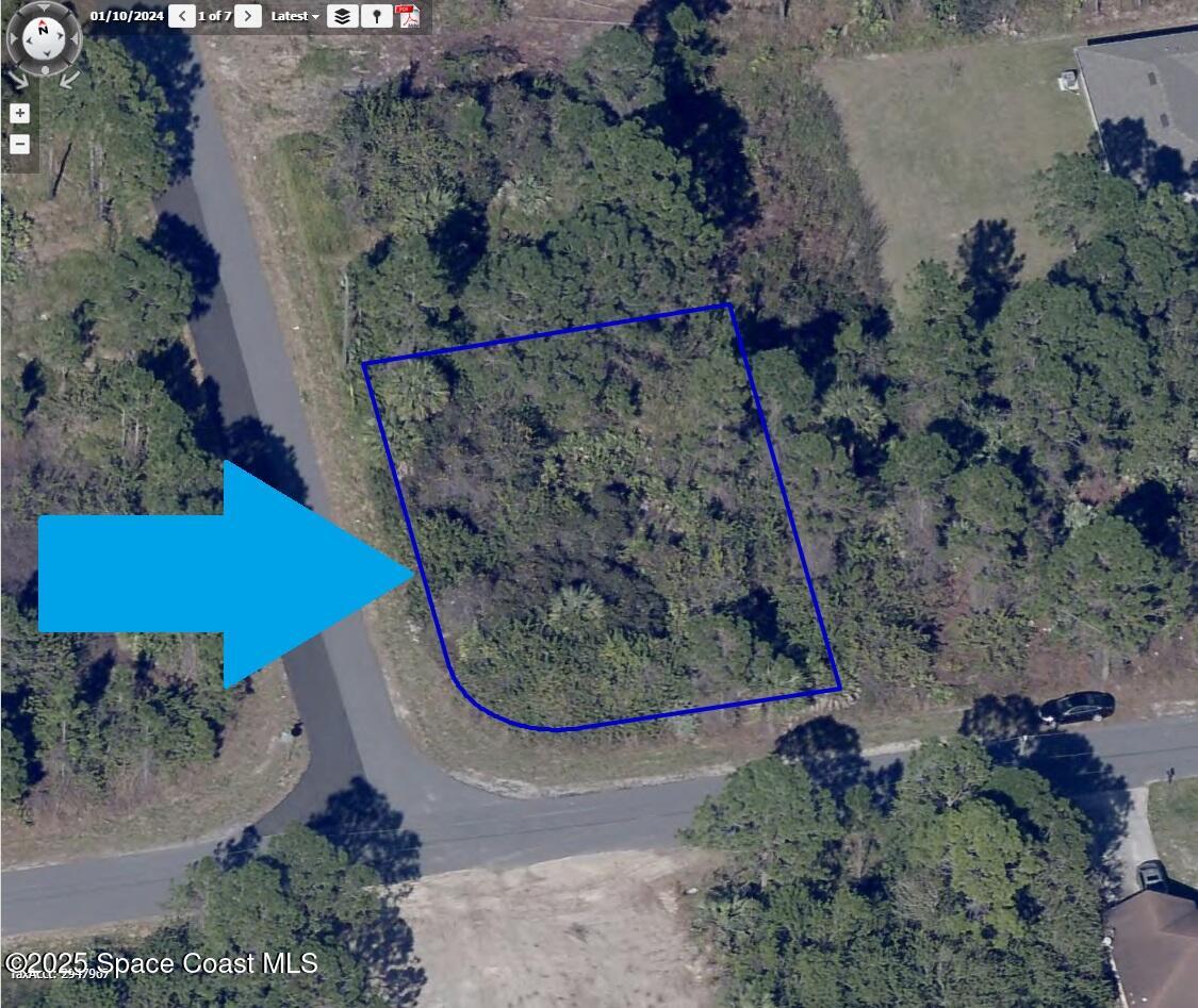 181 Titan Road Southeast Palm Bay, FL 32909 - Photo 4 of 4 an aerial view of a yard with a outdoor space