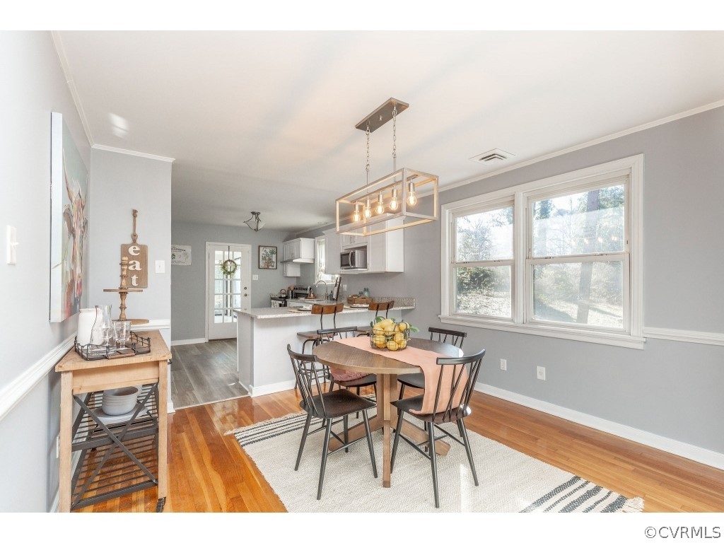 8541 Elm Road Richmond, VA 23235 - Photo 12 of 50 a view of a dining room with furniture window and wooden floor