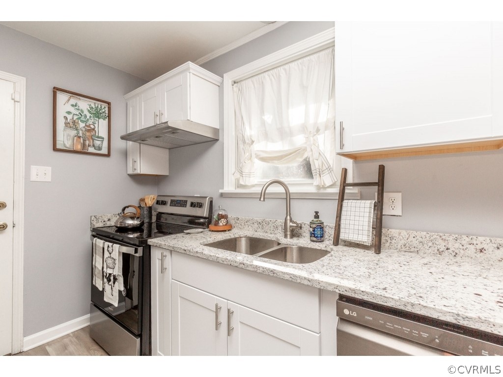 8541 Elm Road Richmond, VA 23235 - Photo 14 of 50 a kitchen with granite countertop a sink a stove and cabinets