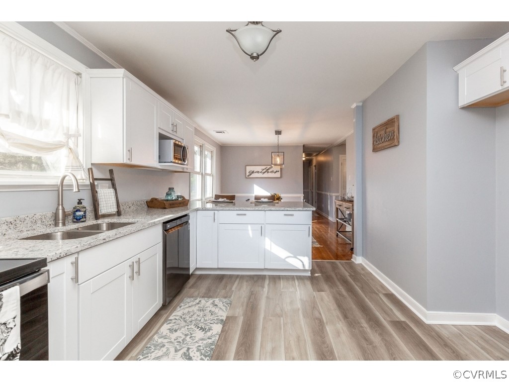 8541 Elm Road Richmond, VA 23235 - Photo 17 of 50 a kitchen with white cabinets and sink