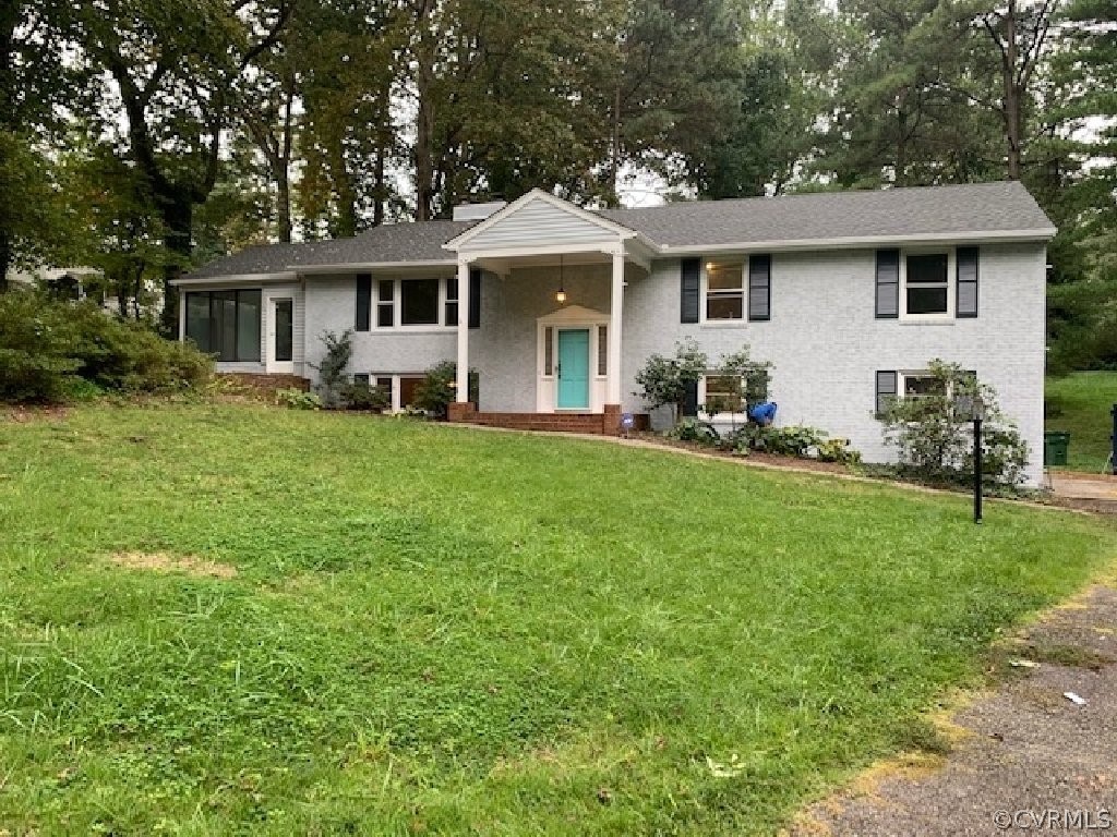8541 Elm Road Richmond, VA 23235 - Photo 2 of 50 a front view of a house with a garden