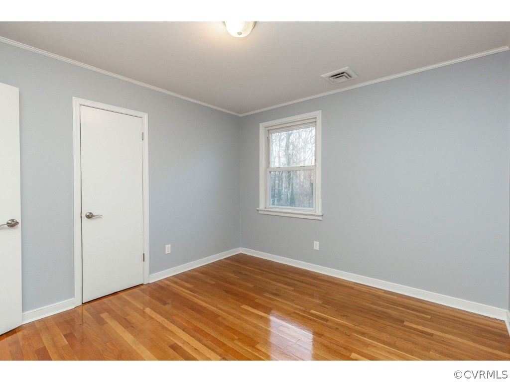 8541 Elm Road Richmond, VA 23235 - Photo 25 of 50 a view of an empty room with wooden floor and a window