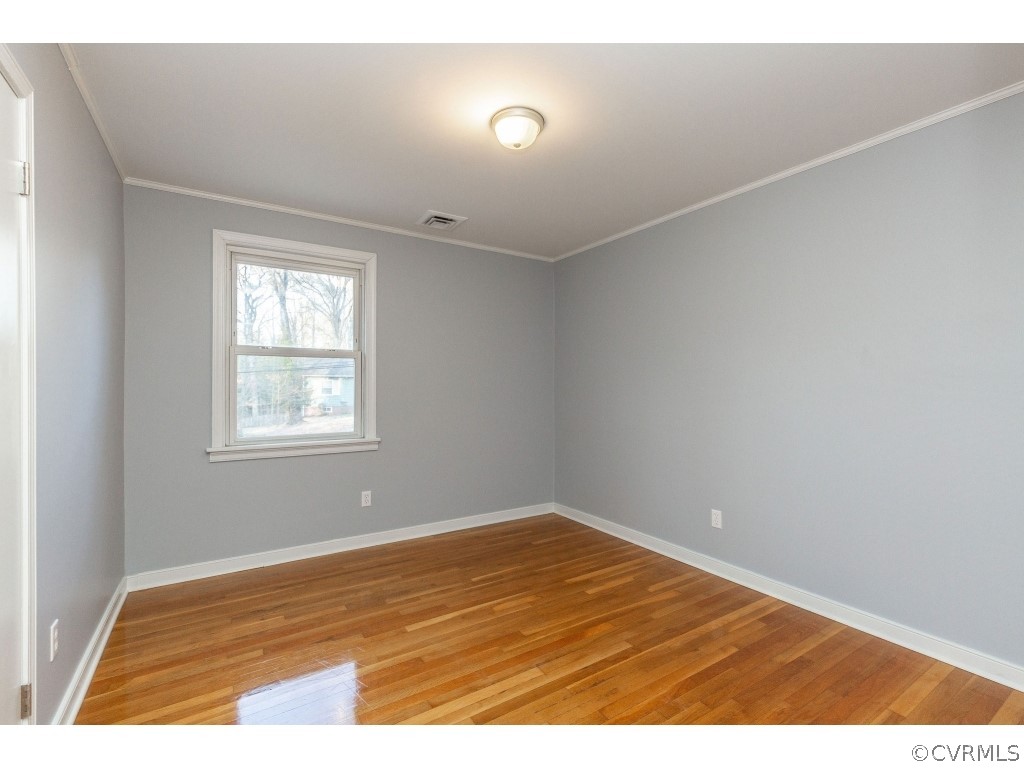 8541 Elm Road Richmond, VA 23235 - Photo 26 of 50 a view of an empty room with wooden floor and windows