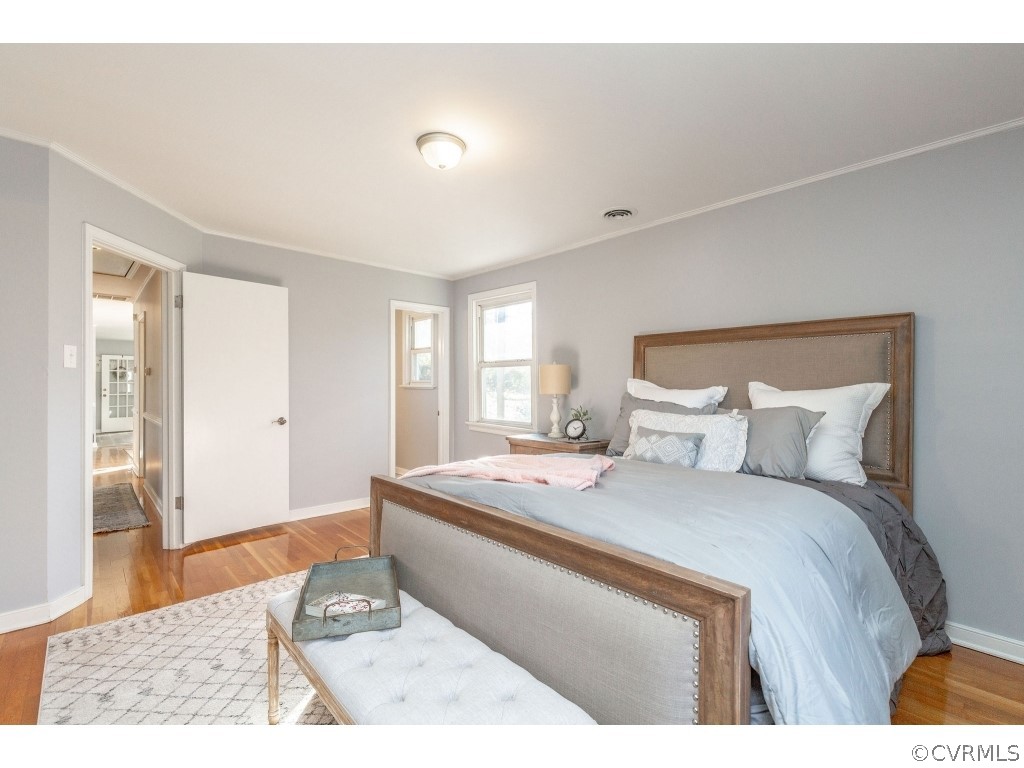 8541 Elm Road Richmond, VA 23235 - Photo 27 of 50 a bedroom with a bed and wooden floor
